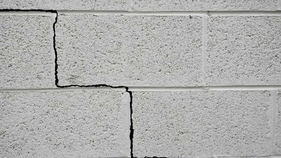 A crack that runs in steps up a block wall